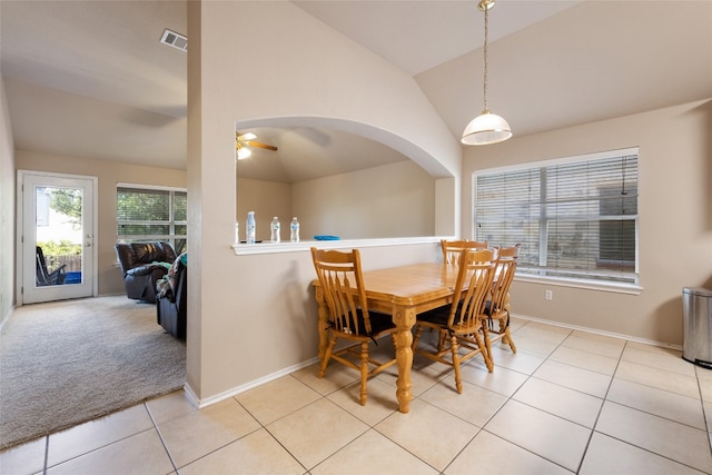 dining area with light carpet, ceiling fan, and high vaulted ceiling