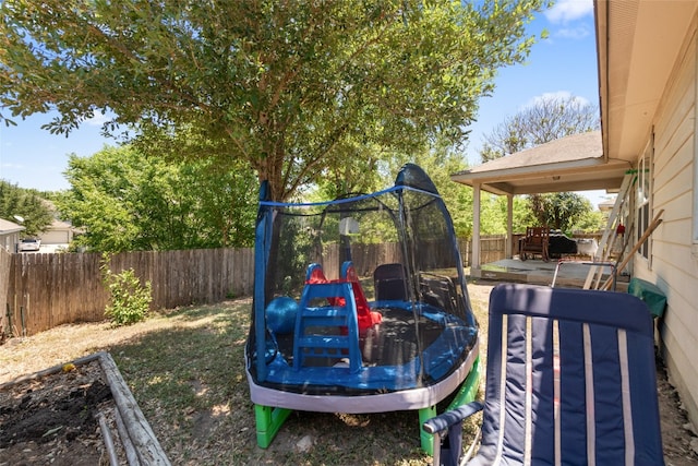 view of jungle gym with a trampoline