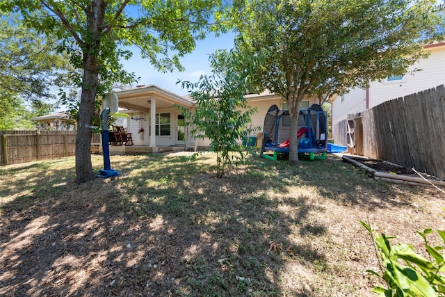 view of yard featuring a patio and a trampoline