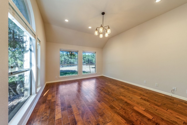 unfurnished room featuring a chandelier, vaulted ceiling, and dark hardwood / wood-style flooring