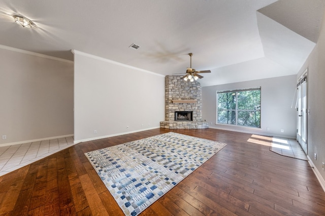 living room featuring dark hardwood / wood-style flooring, ceiling fan, brick wall, and a fireplace