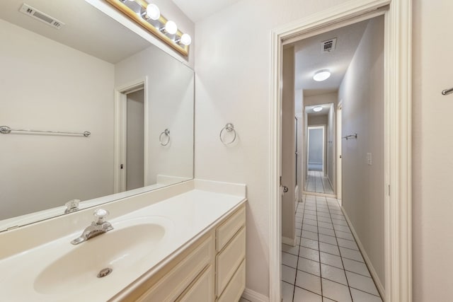 bathroom with tile flooring and large vanity