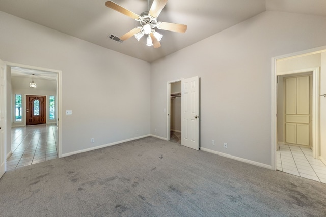 carpeted empty room featuring lofted ceiling and ceiling fan