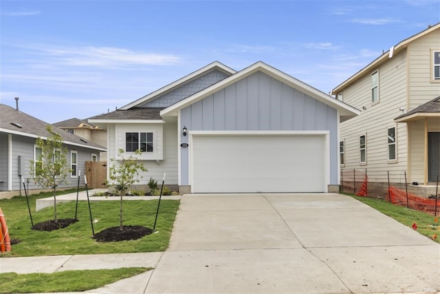 view of front facade with a garage and a front lawn