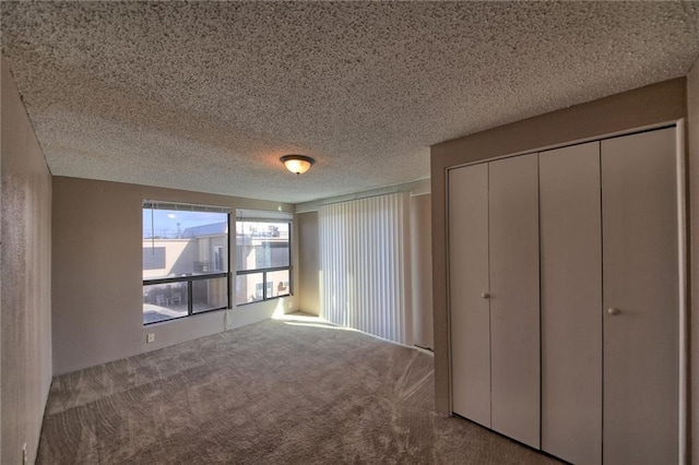 unfurnished bedroom featuring carpet floors and a textured ceiling