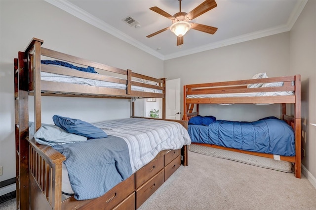 carpeted bedroom with ceiling fan and ornamental molding