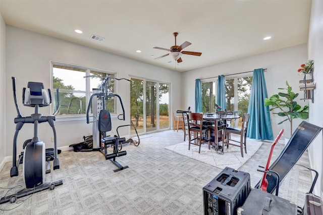 exercise room featuring ceiling fan and light carpet