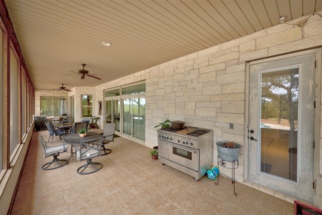 view of patio / terrace with ceiling fan and a baseboard radiator