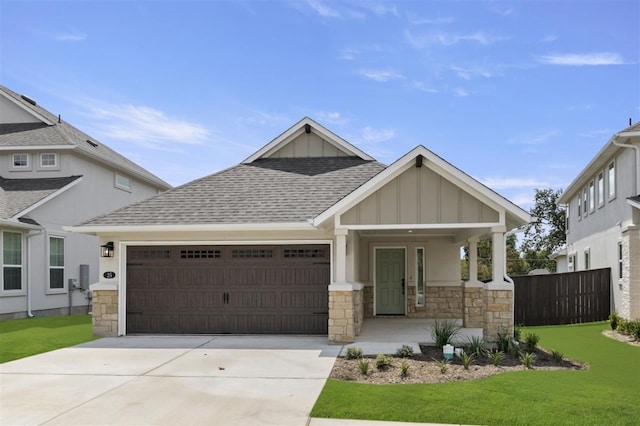 craftsman-style house with a garage, a front yard, and a porch