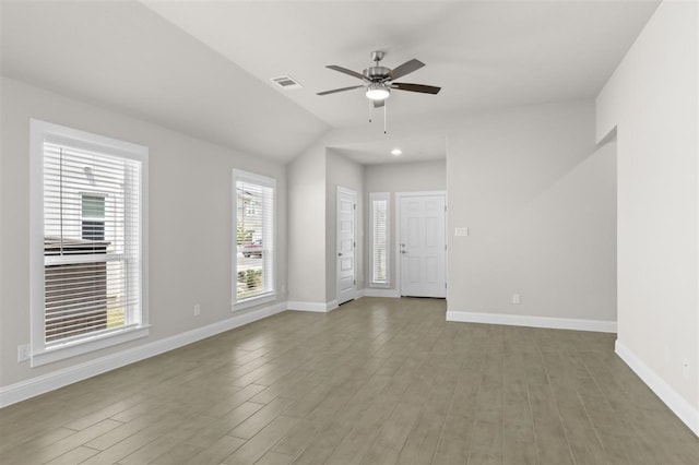 unfurnished room with ceiling fan, hardwood / wood-style floors, and vaulted ceiling