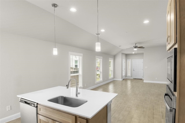 kitchen with decorative light fixtures, an island with sink, sink, ceiling fan, and stainless steel dishwasher