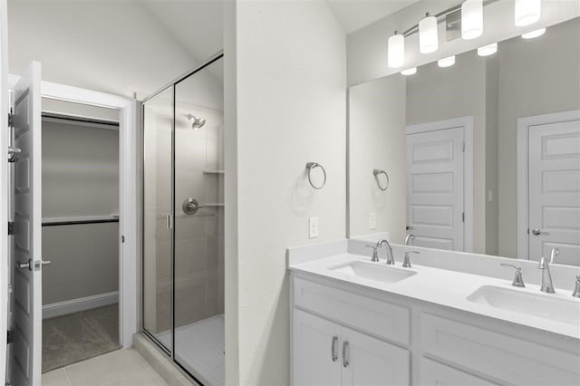 bathroom with vanity, a shower with shower door, and tile patterned floors