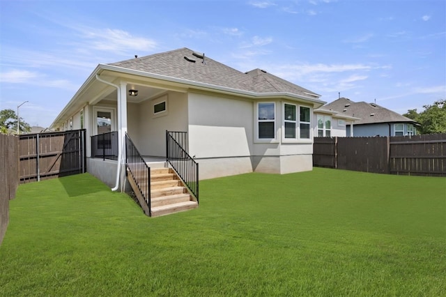 rear view of property with a lawn