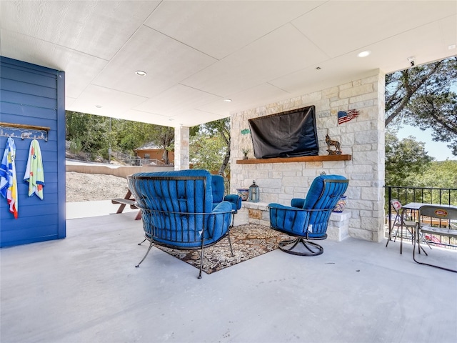 view of patio featuring an outdoor stone fireplace