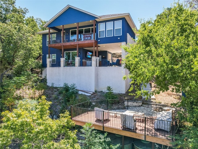 back of house featuring a balcony