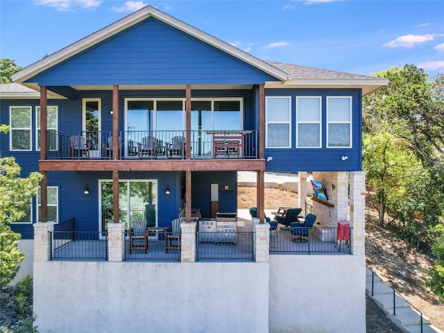 back of property featuring outdoor lounge area, a patio, and a balcony