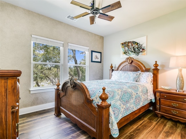 bedroom with ceiling fan and dark hardwood / wood-style floors