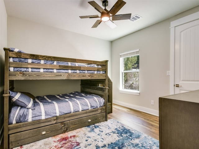 bedroom with wood-type flooring and ceiling fan