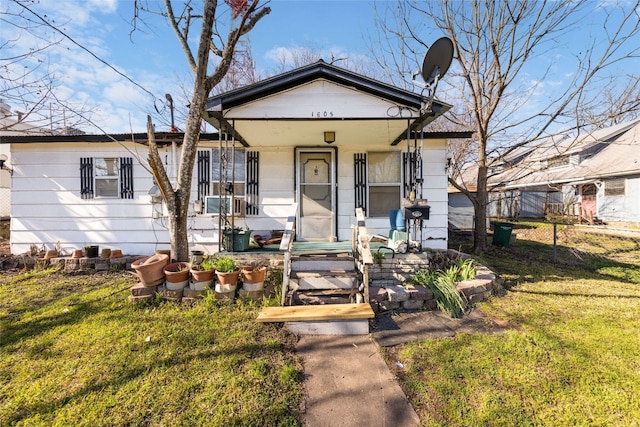 bungalow-style house featuring a front yard