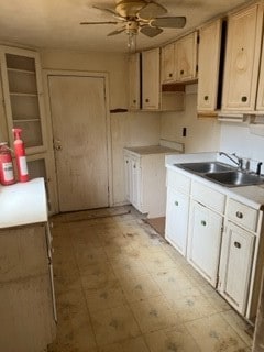 kitchen featuring ceiling fan, light tile floors, and sink