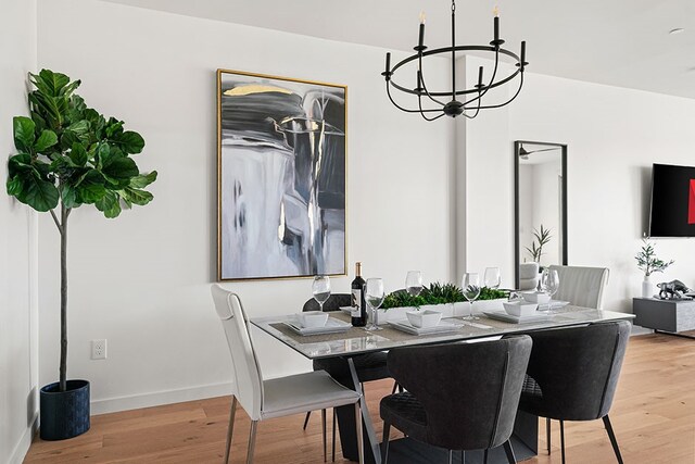 dining room featuring light hardwood / wood-style floors and an inviting chandelier