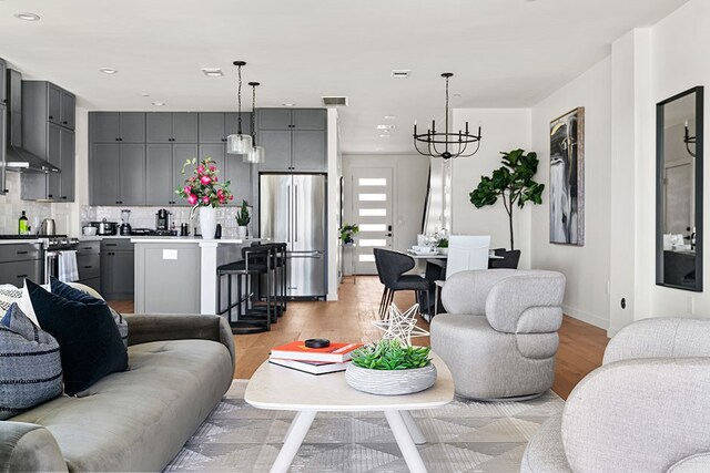 living room with light hardwood / wood-style floors and a chandelier