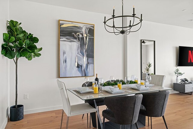 dining room featuring light hardwood / wood-style flooring and a chandelier