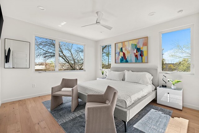 bedroom with ceiling fan and light hardwood / wood-style floors