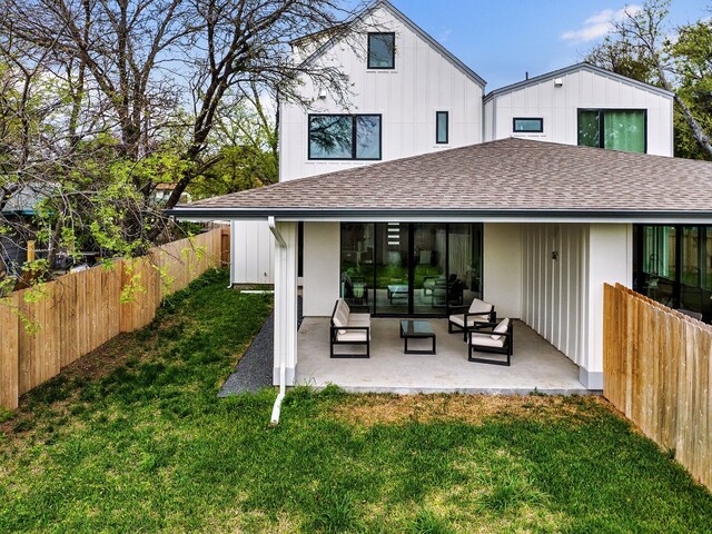 back of property featuring a patio, a yard, and an outdoor living space