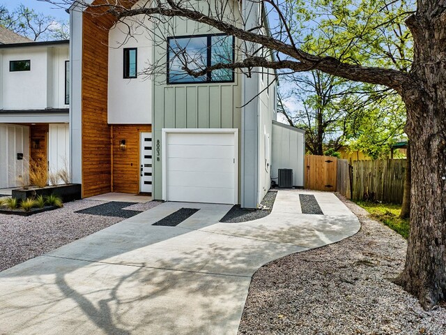 view of front facade with central AC and a garage