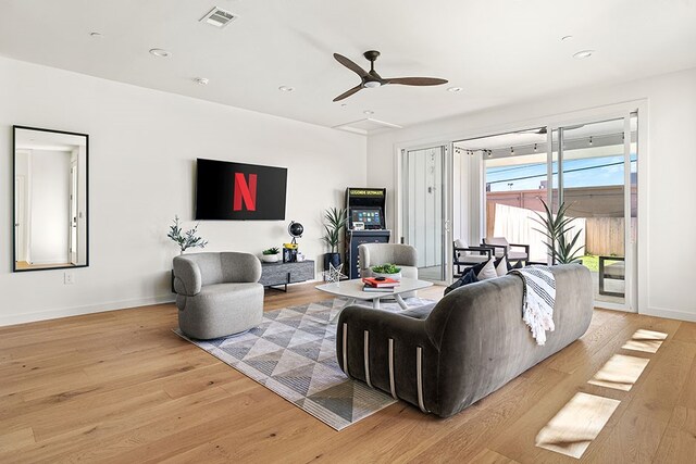 living room featuring ceiling fan and light wood-type flooring