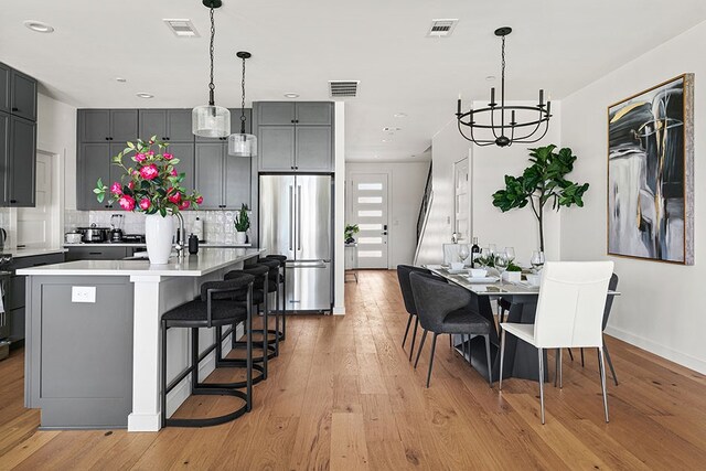 interior space with an inviting chandelier and light hardwood / wood-style floors