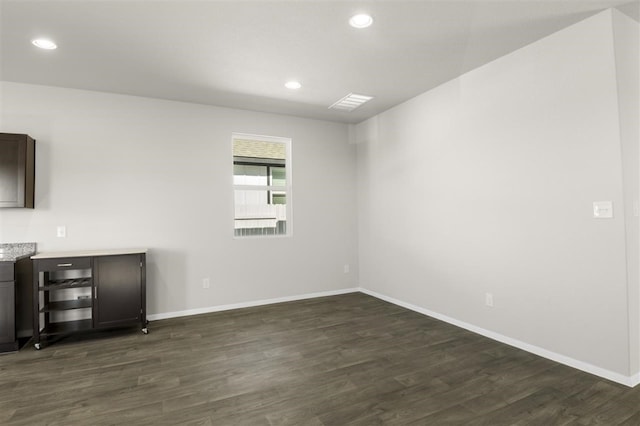 spare room featuring dark hardwood / wood-style floors