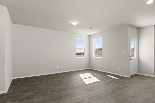 empty room featuring dark wood-type flooring