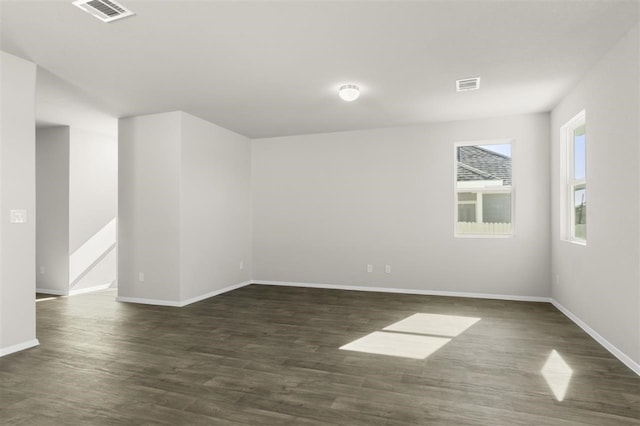 spare room with dark wood-type flooring