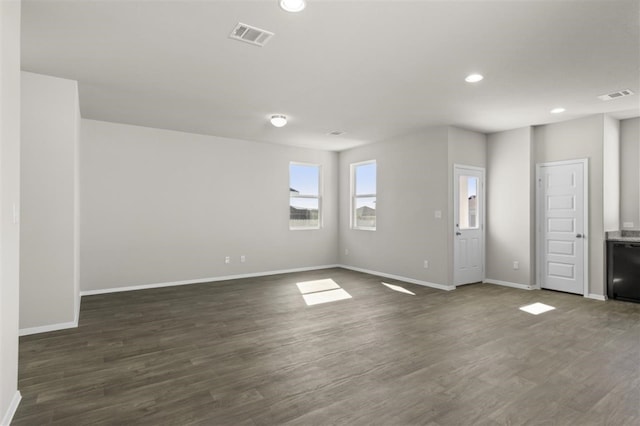 unfurnished living room featuring dark hardwood / wood-style flooring