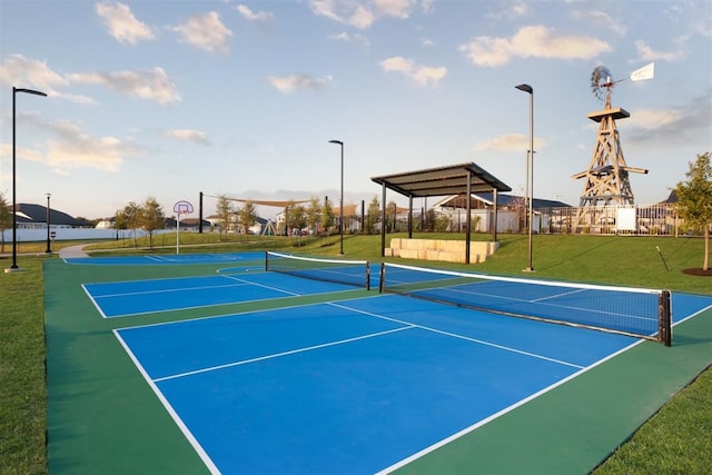 view of sport court with a lawn