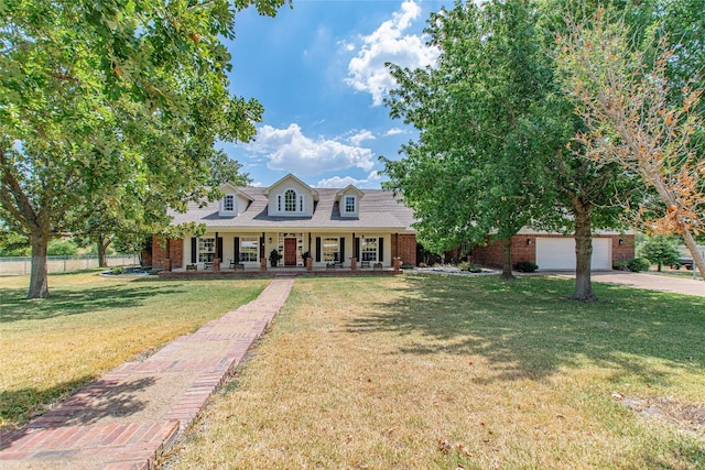 new england style home featuring a front lawn and a porch