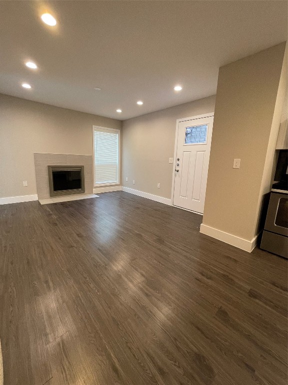 unfurnished living room featuring dark hardwood / wood-style floors