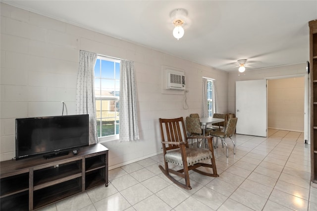 sitting room with light tile floors, ceiling fan, and a wall unit AC