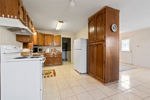 kitchen featuring white appliances and light tile floors