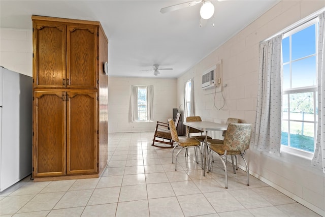 living area featuring ceiling fan, light tile flooring, and a wall mounted air conditioner