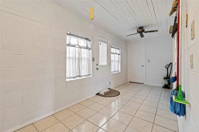 tiled entrance foyer with ceiling fan and wood ceiling