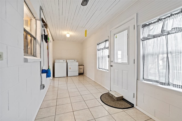 tiled foyer with washing machine and dryer and wood ceiling