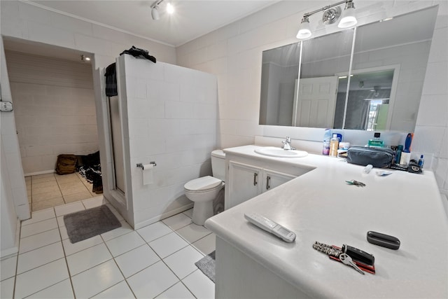 bathroom with tile flooring, tile walls, and toilet