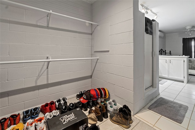 mudroom with ceiling fan and light tile floors