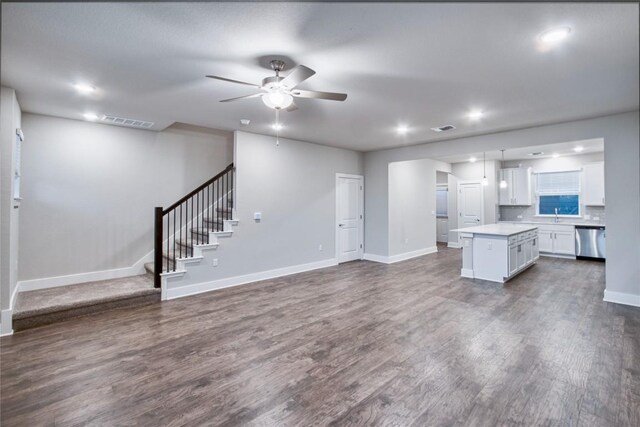 unfurnished living room featuring sink, hardwood / wood-style floors, and ceiling fan