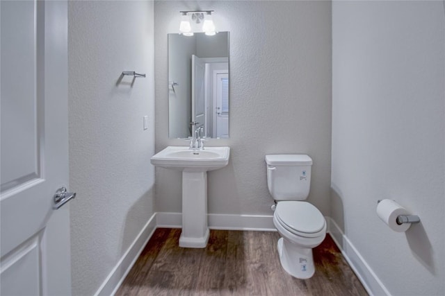 bathroom featuring sink, hardwood / wood-style flooring, and toilet