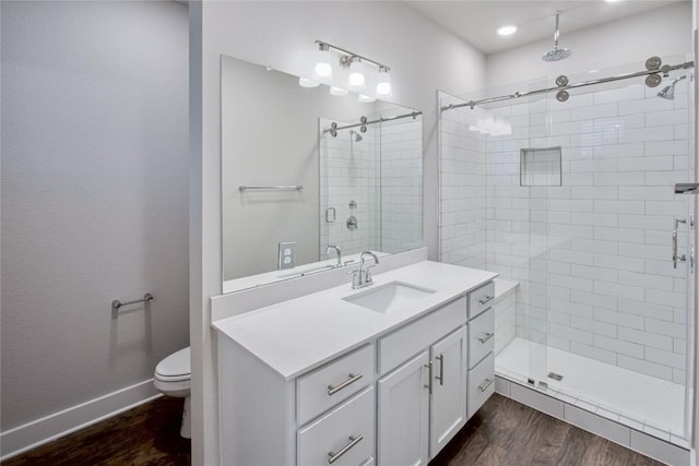 bathroom with vanity, wood-type flooring, toilet, and walk in shower