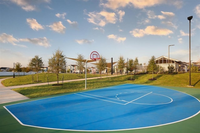 view of basketball court featuring a yard